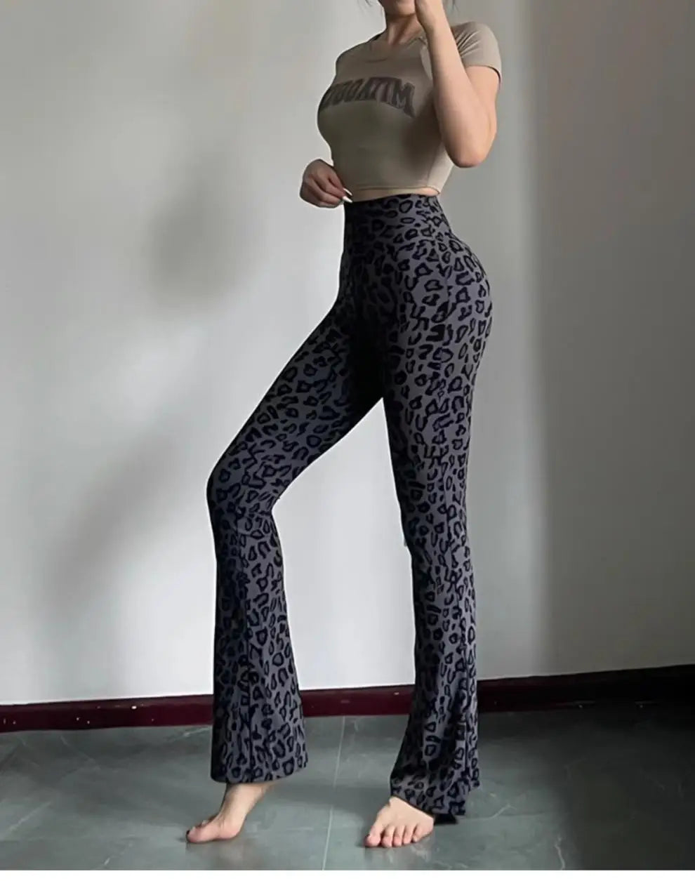 Leopard print yoga pants are breathable and make legs look longer. Slightly flared pants. High-waisted sports Pilates pants.