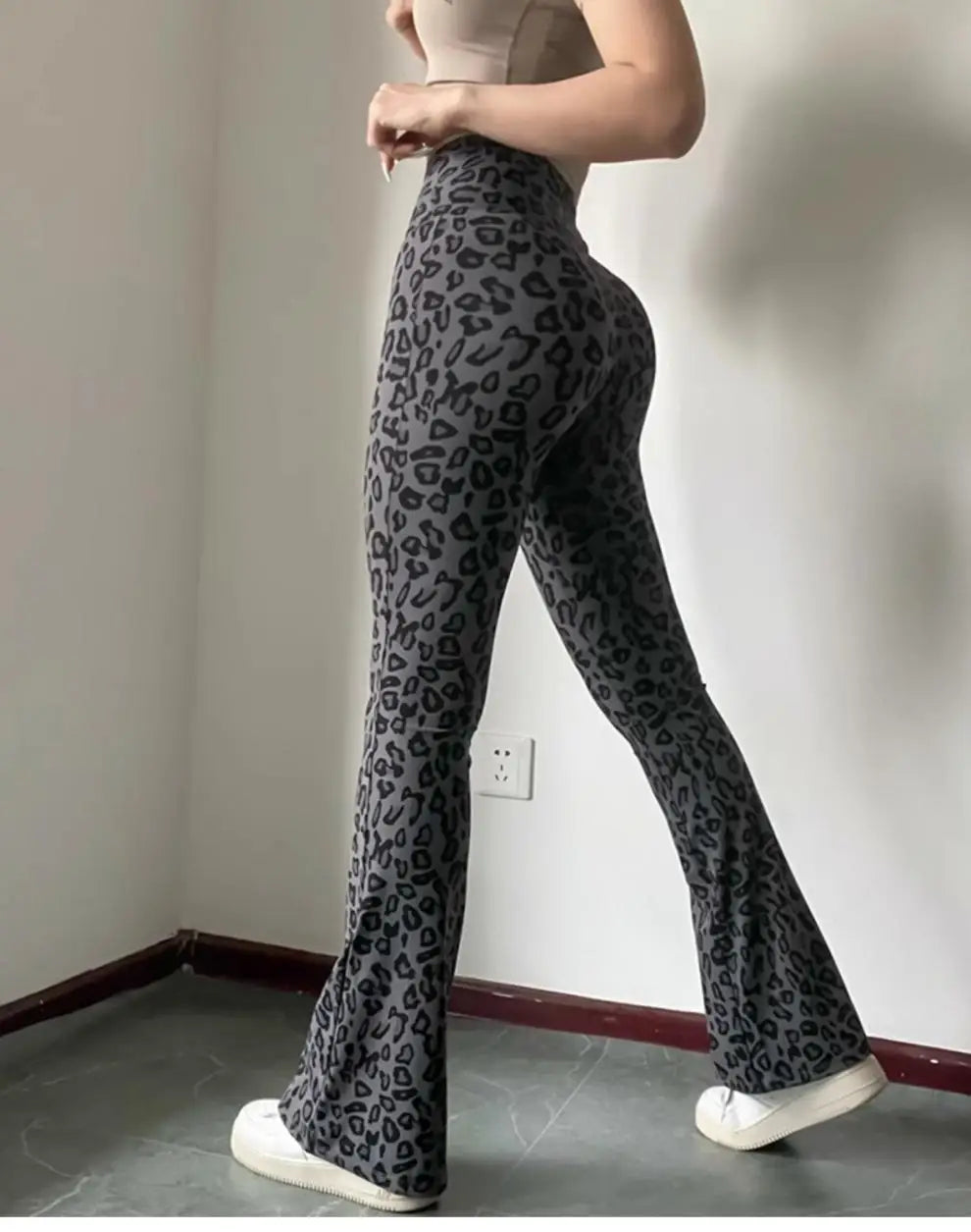 Leopard print yoga pants are breathable and make legs look longer. Slightly flared pants. High-waisted sports Pilates pants.