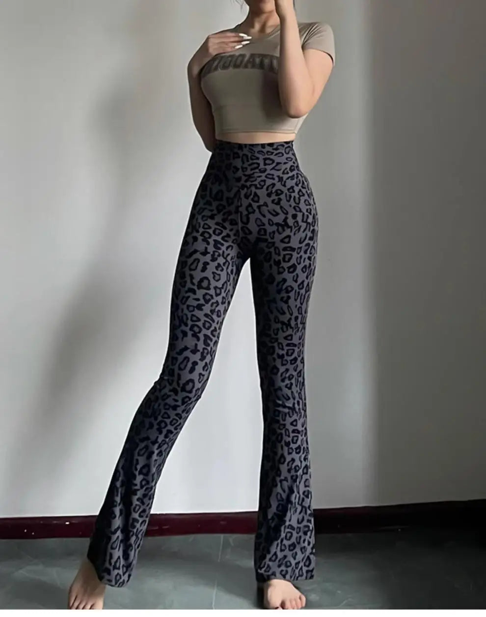Leopard print yoga pants are breathable and make legs look longer. Slightly flared pants. High-waisted sports Pilates pants.