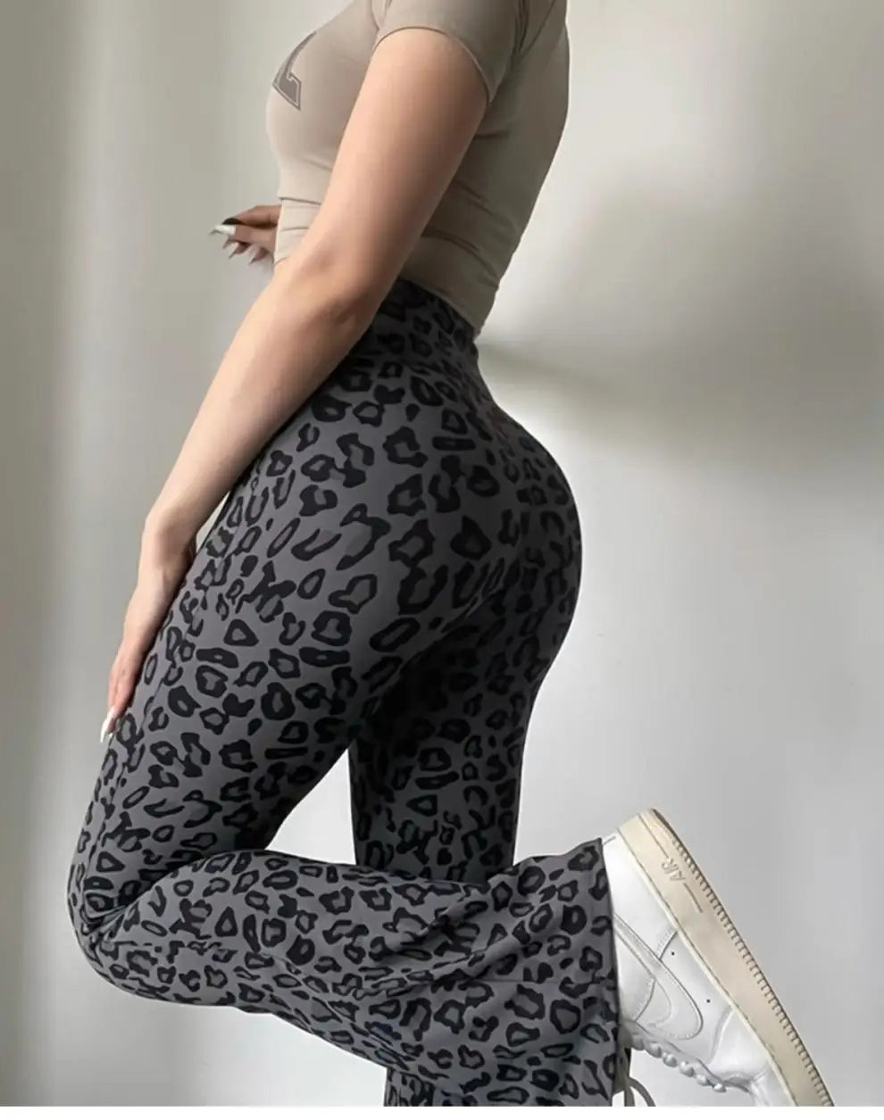 Leopard print yoga pants are breathable and make legs look longer. Slightly flared pants. High-waisted sports Pilates pants.